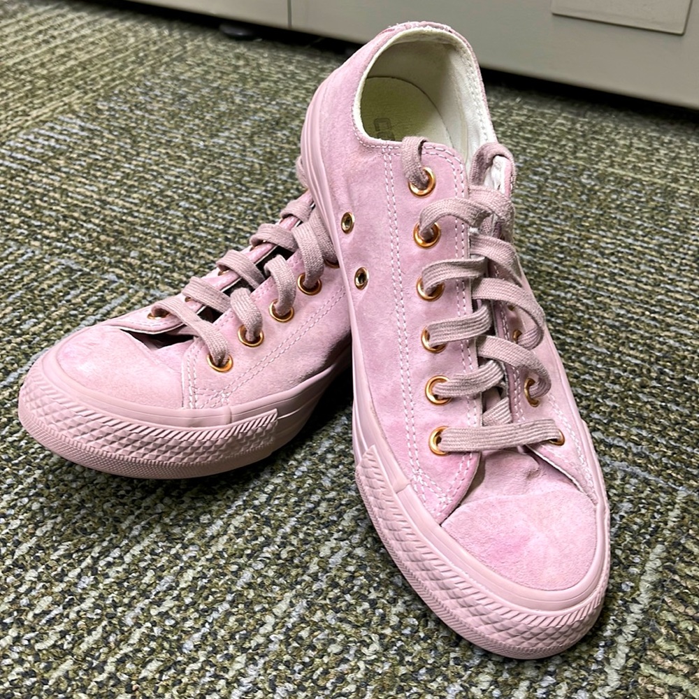 Pink converse with rose gold accents.